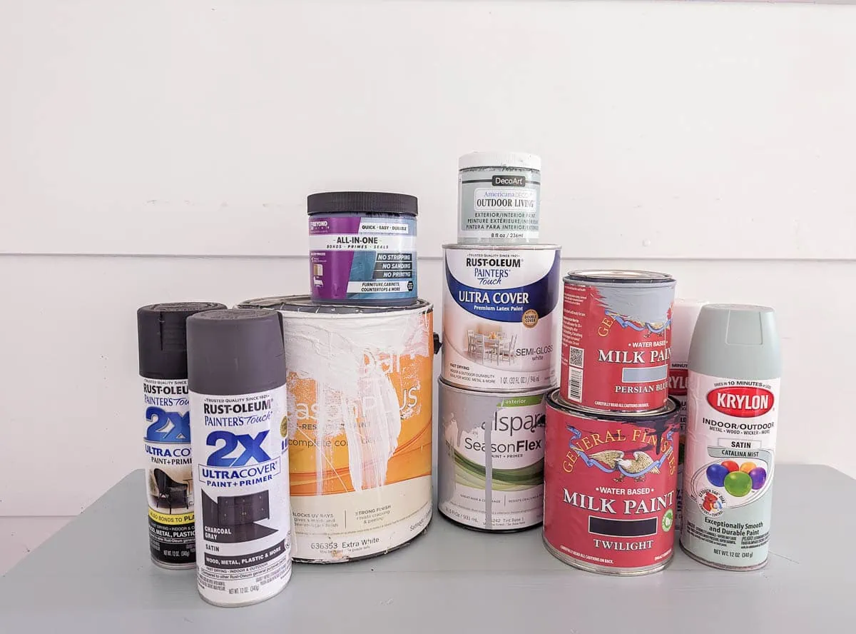 stack of cans of various outdoor furniture paints.