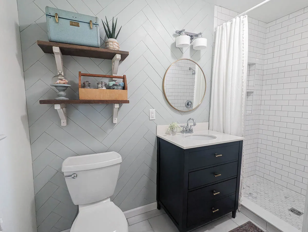 Dark navy vanity in small master bathroom.