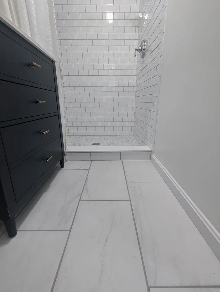 Small bathroom with marble-look porcelain tiles.