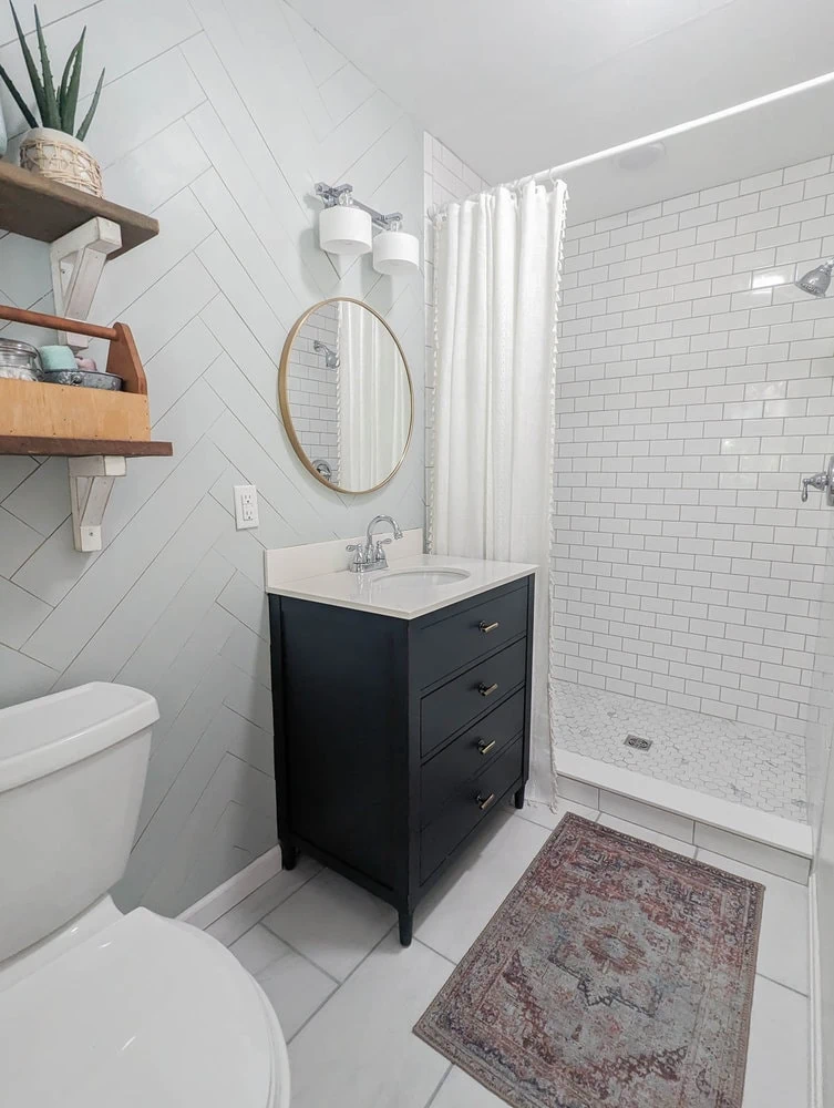small master bathroom after remodel with new tile flooring, new walk in shower, and new vanity.