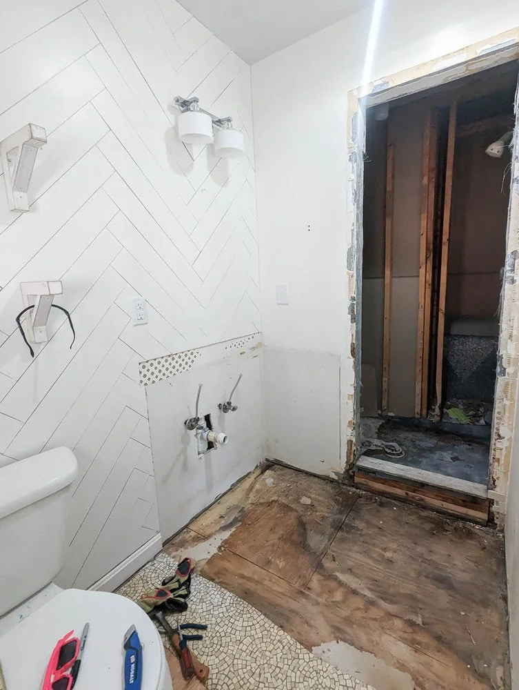 bathroom after tile shower is demolished.