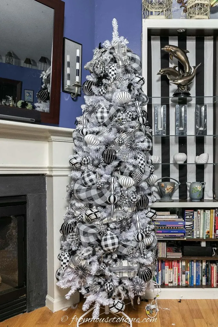 Black and white tree with plaid ribbon and patterned ornaments.