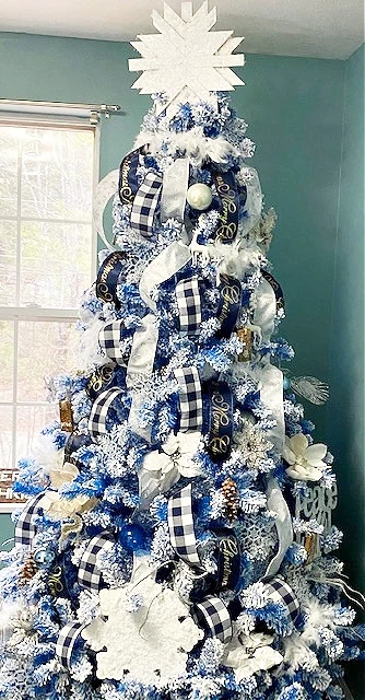 Christmas tree with black, white, and blue decorations.