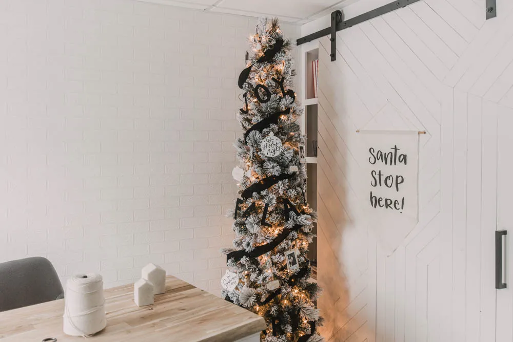 slim Christmas tree with black ribbon.