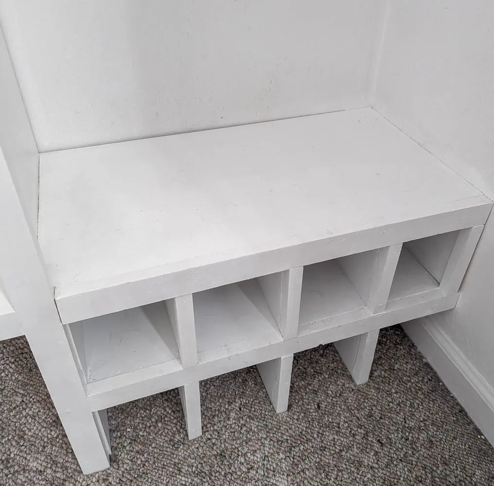 close up of shoe shelves on floor of DIY closet organizer.