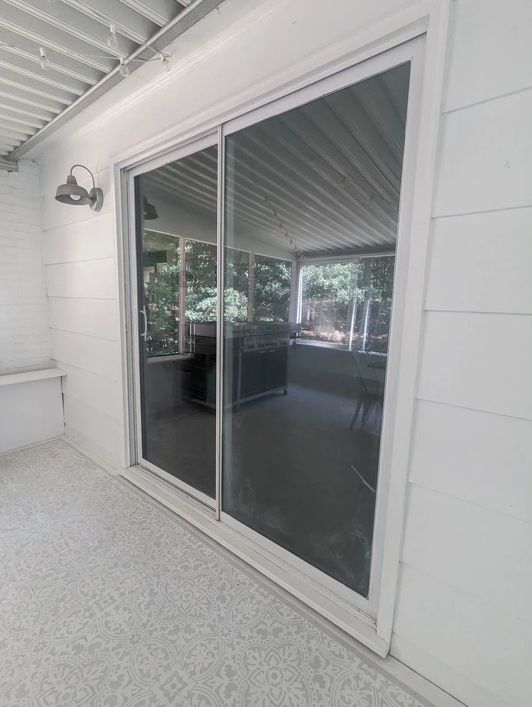sliding glass doors with the frames painted white.