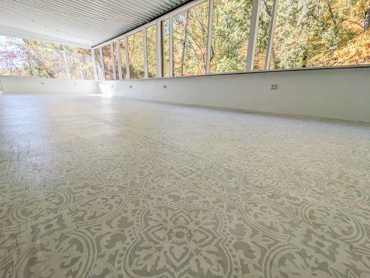 white and gray painted porch surrounded by views of beauitful trees.