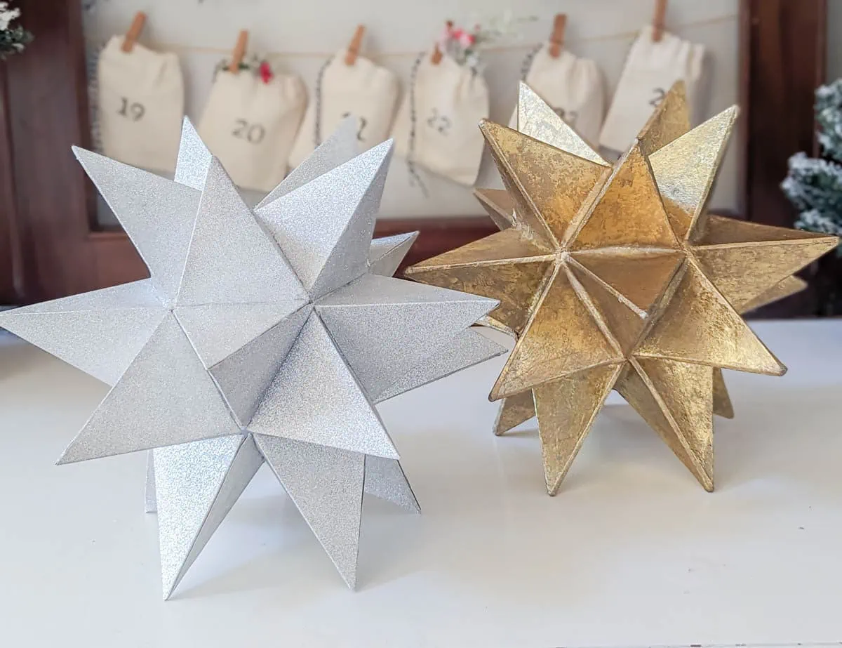 DIY Christmas tree star next to thrifted gold star.