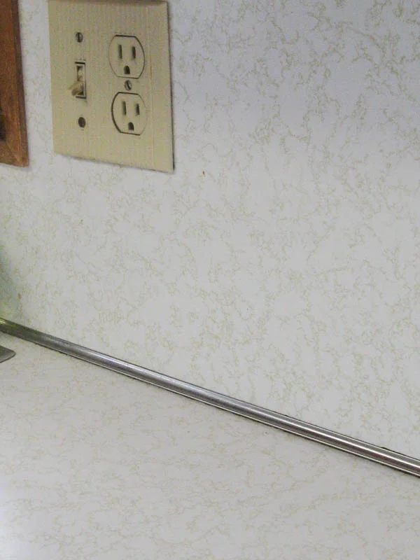 dated laminate countertops with gold squiggly line pattern.