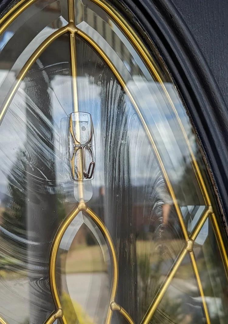 clear command hook on glass door.