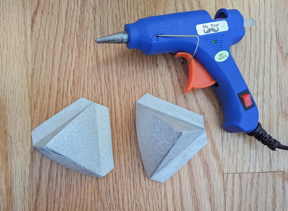 paper points to make star next to hot glue gun.