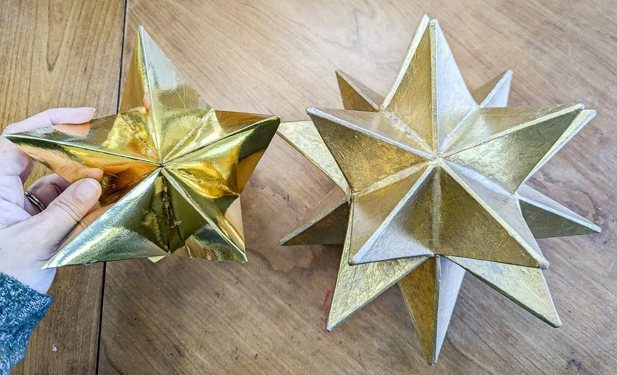holding the first five pointed star of a 3d moravian star.