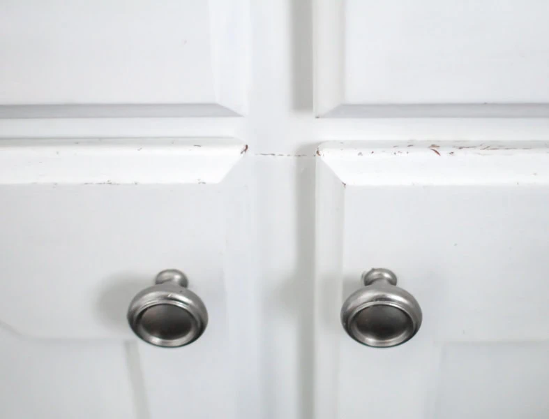 close up of chips on white cabinets.