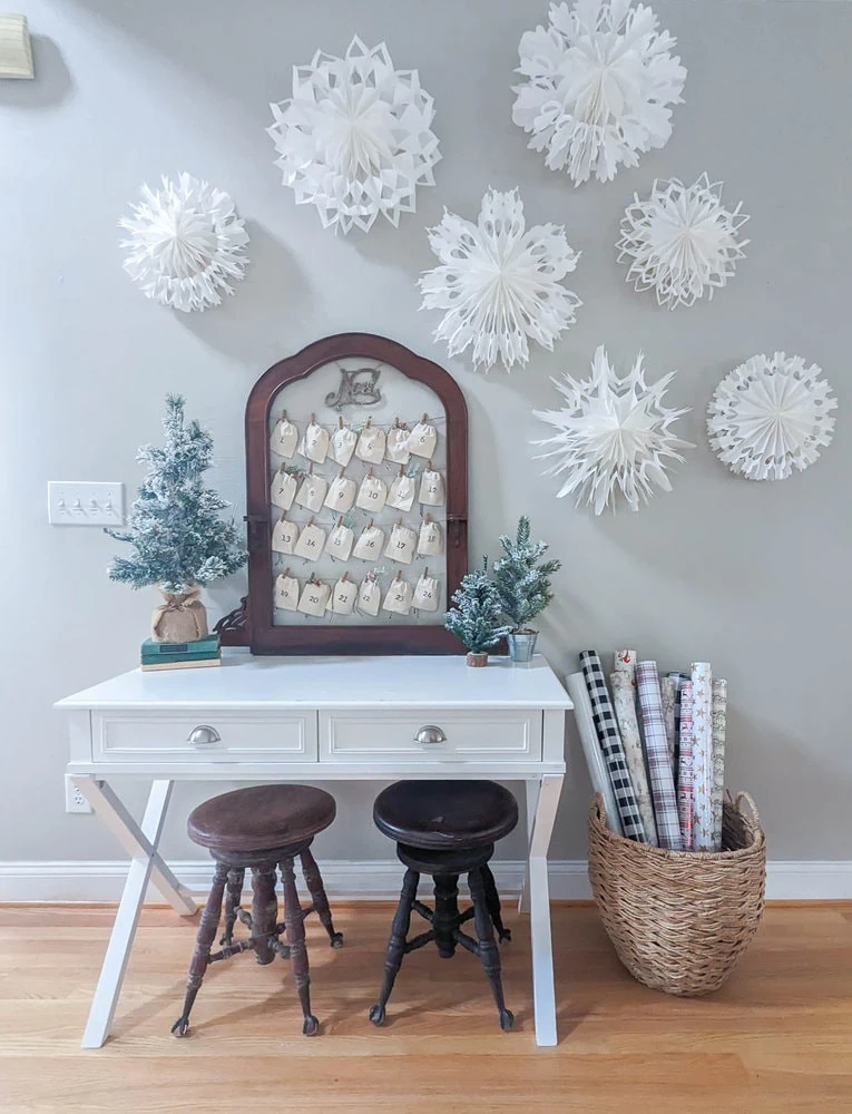 paper bag snowflakes on wall next to advent calendar.