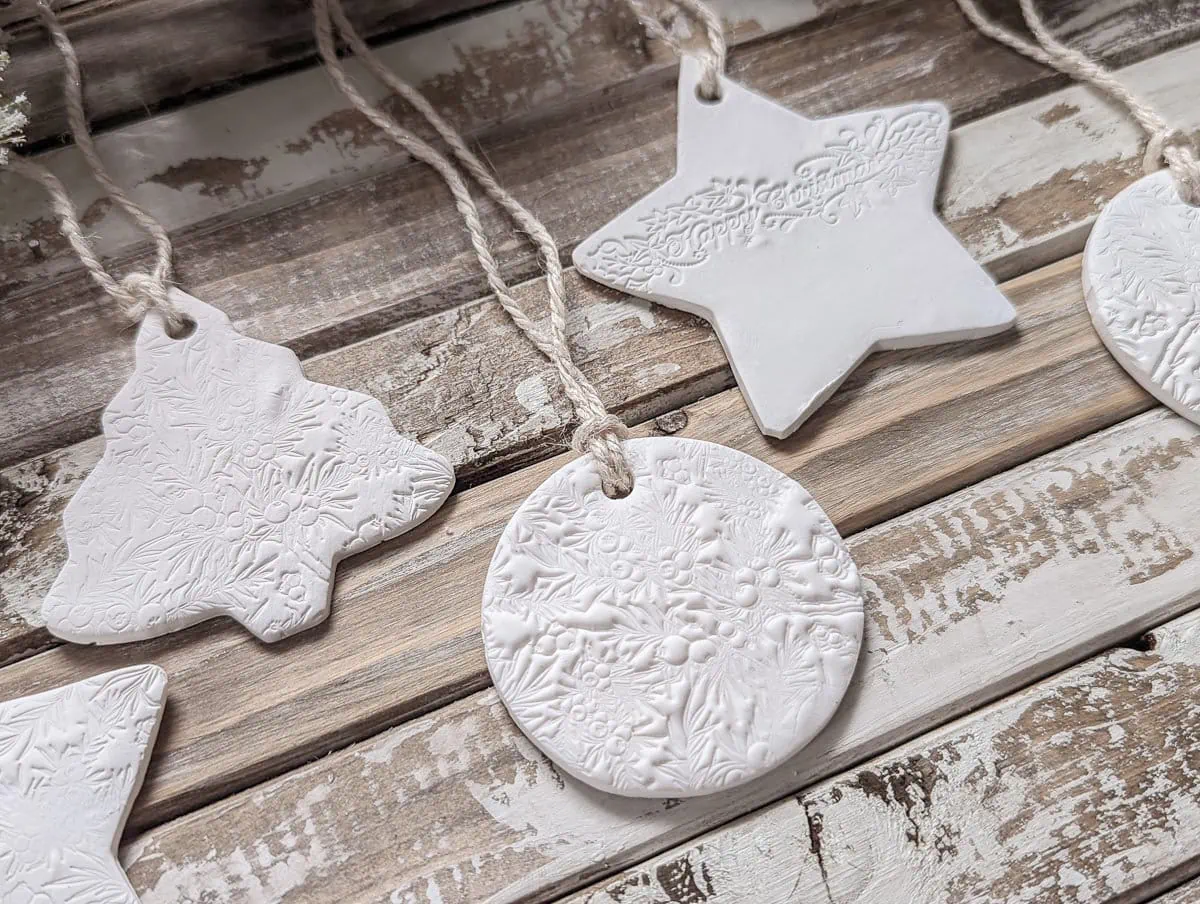 diy clay ornaments against a rustic wood background.