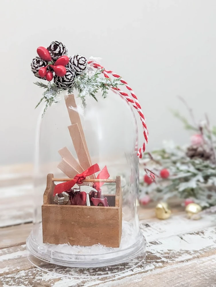 diy snow globe ornament with tiny toolbox inside.