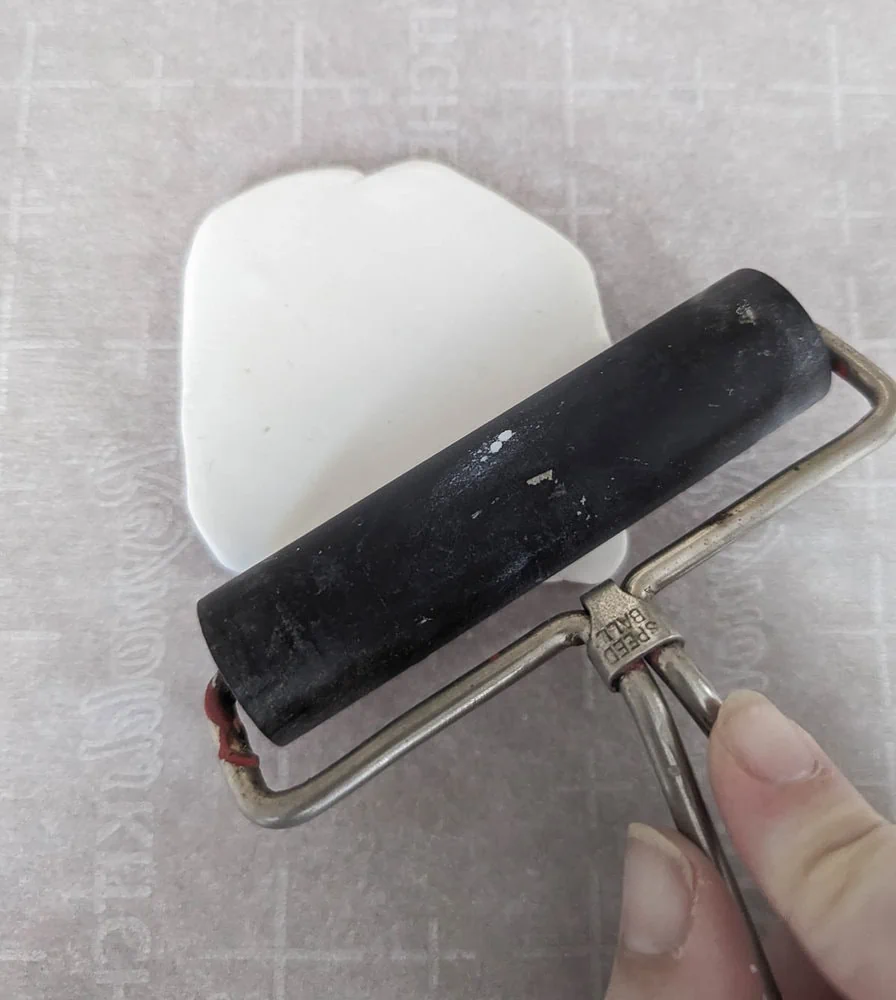 rolling out clay using a brayer.