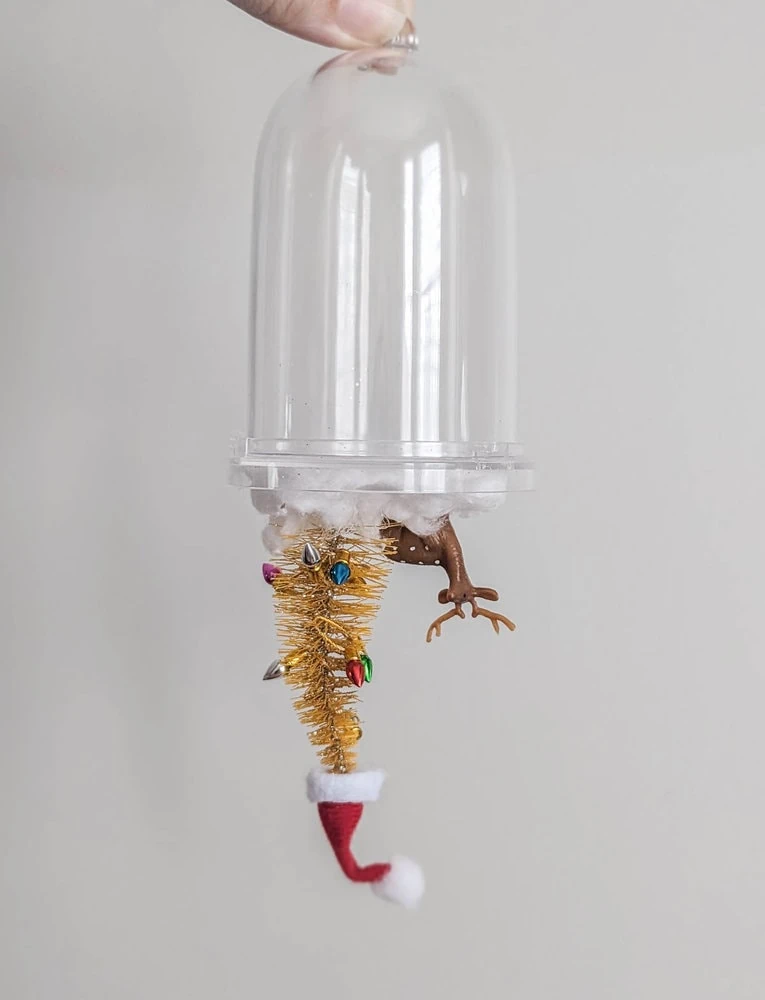 diy snow globe ornament with everything attached to the wrong side.
