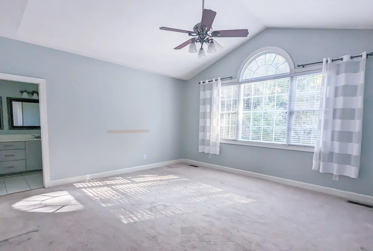 large primary bedroom with vaulted ceiling.