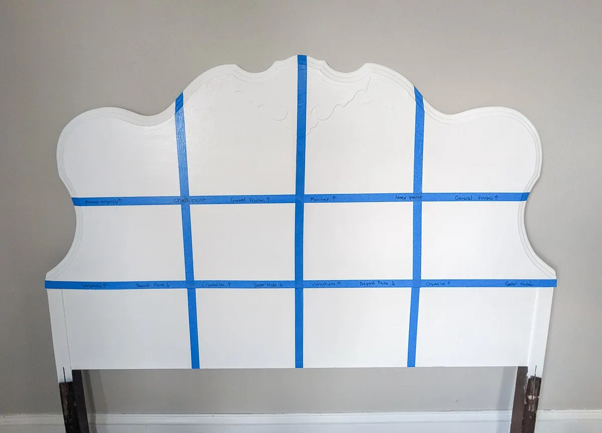 wooden headboard painted white and divided into twelve sections using painter's tape.