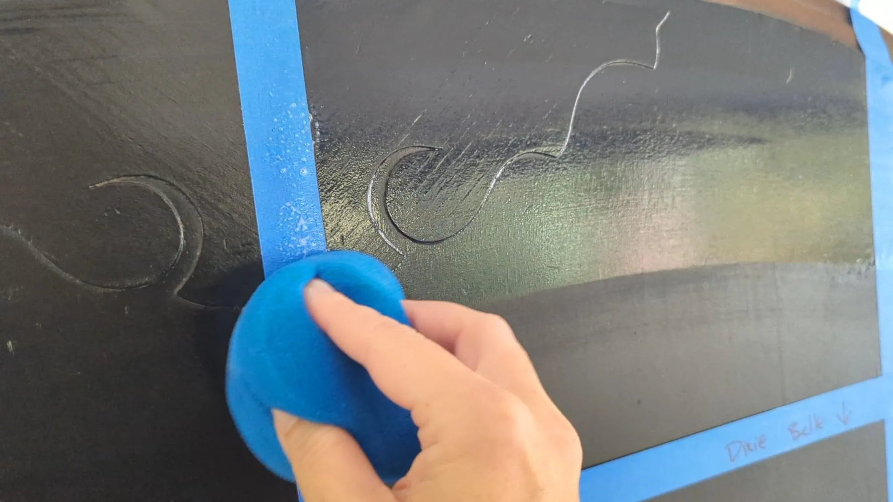 applying sealer using a blue sponge applicator.