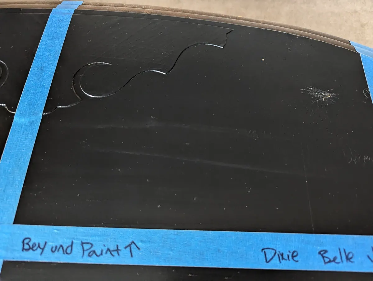 section of black paint with two stripes where beyond paint sealer was applied.