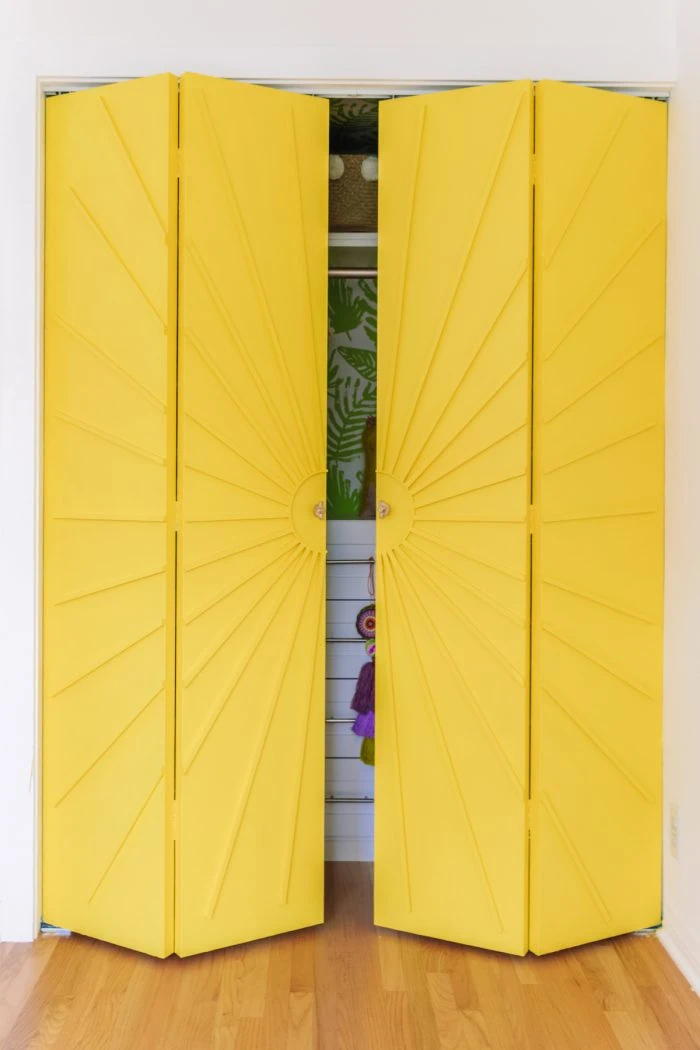 yellow closet door with sunburst molding.
