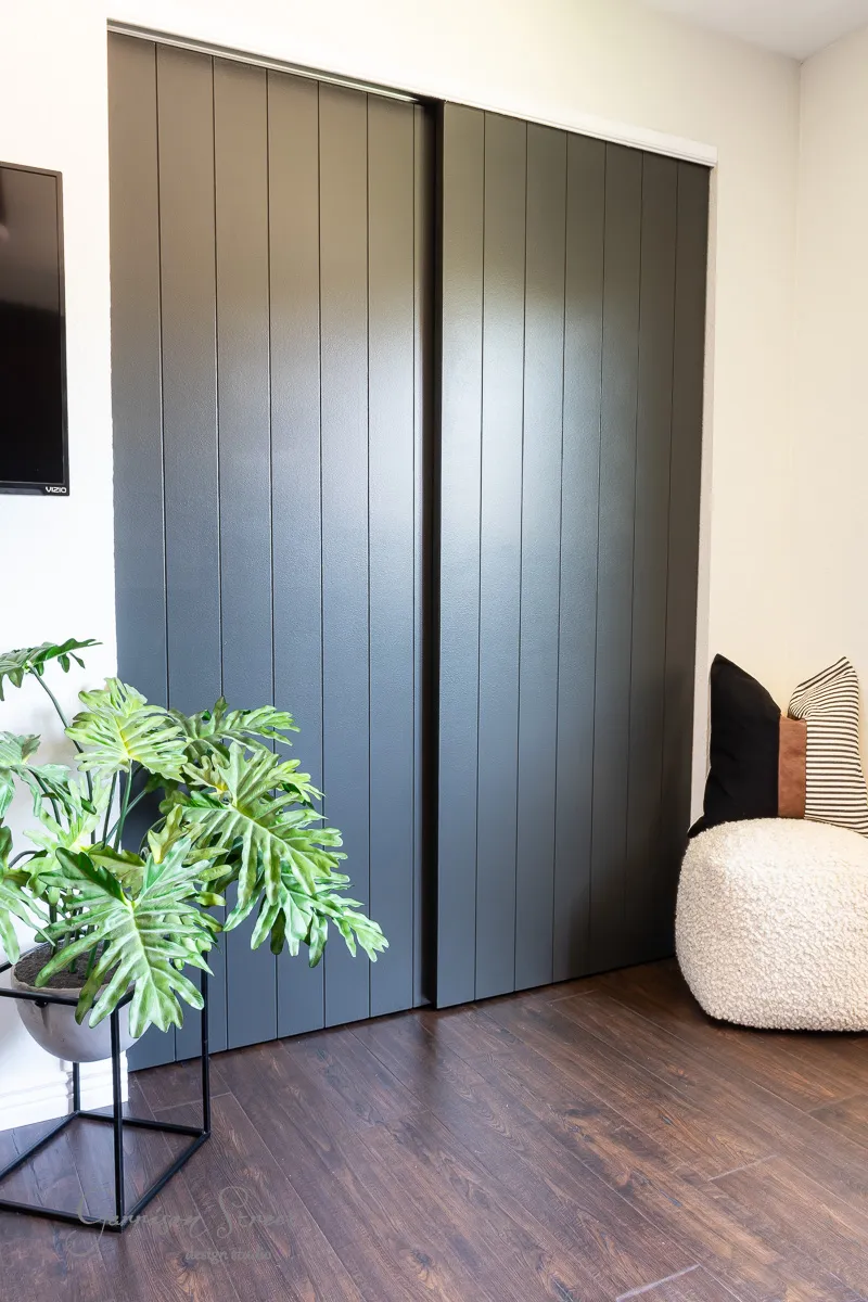 sliding doors with wood planks painted dark gray.