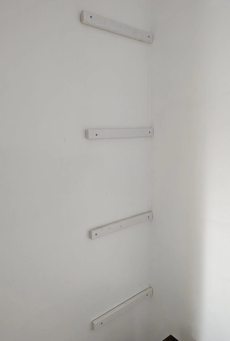 shelf supports attached to closet wall.