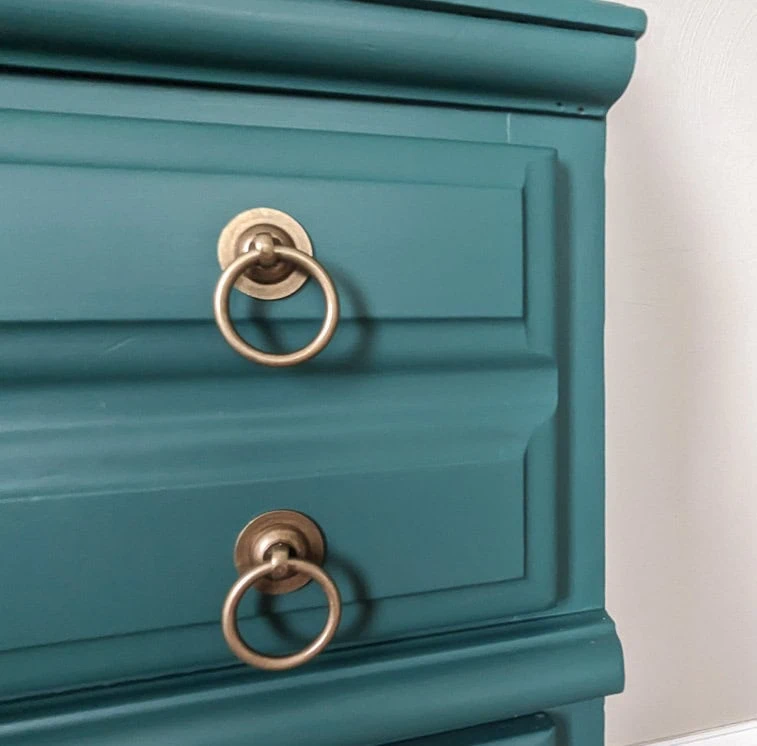 green drawer with brass hardware.