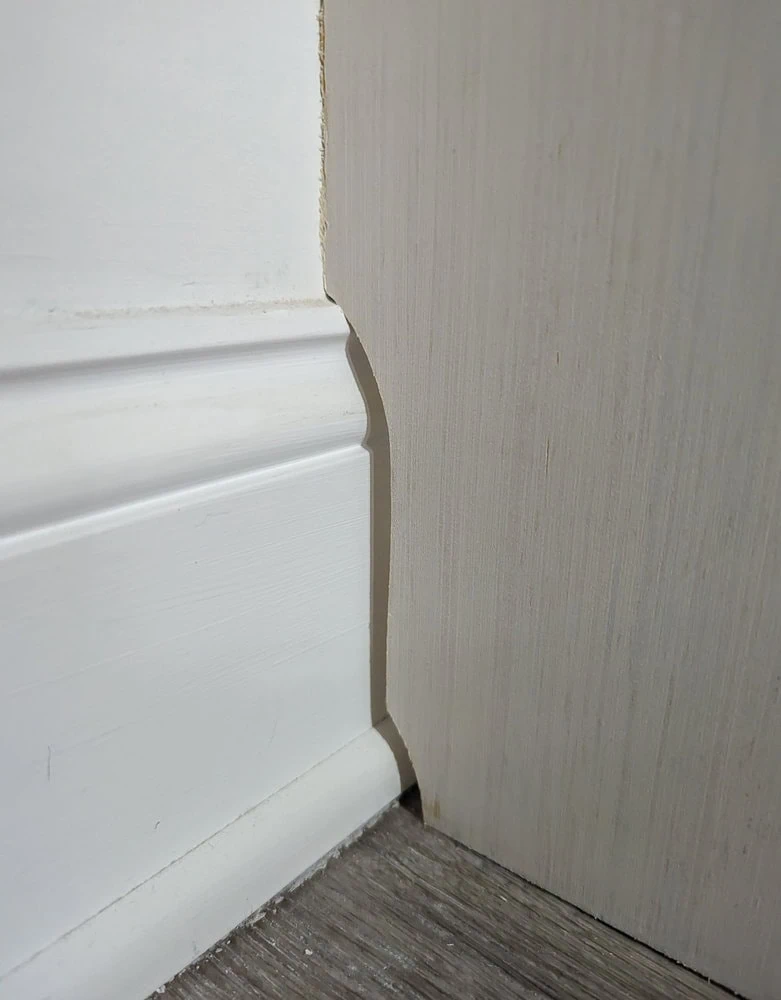 closet organizer cut around baseboards.