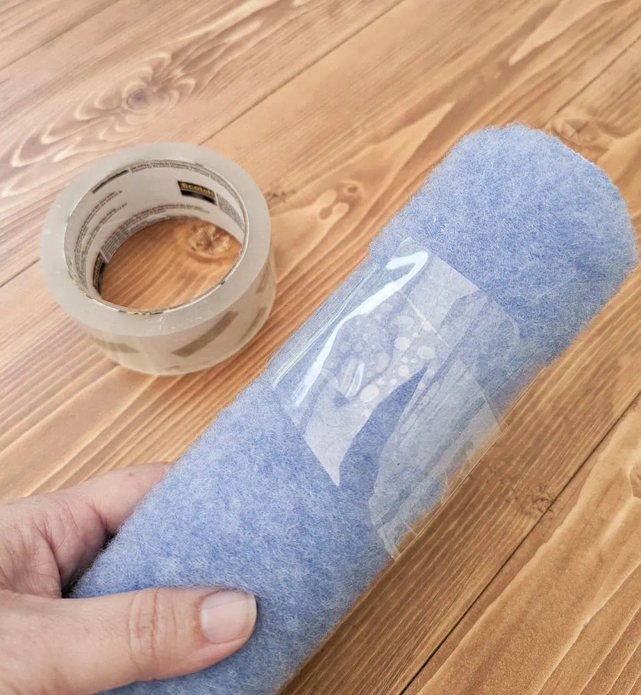 packing tape wrapped around a paint roller to remove fuzz.