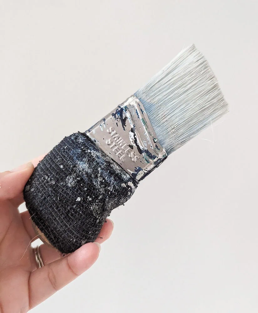zibra palm pro paint brush wrapped with an adhesive bandage for a more comfortable handle.