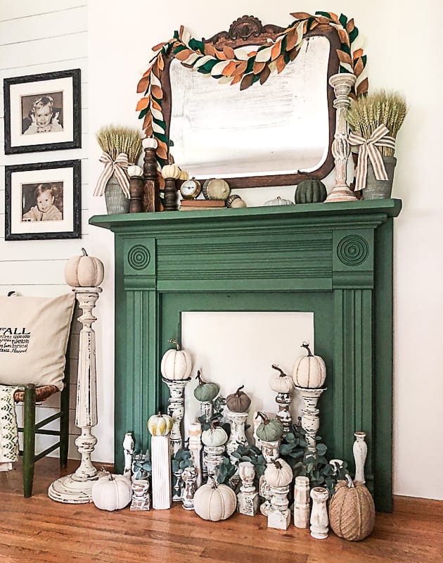green painted wood fireplace decorated for fall