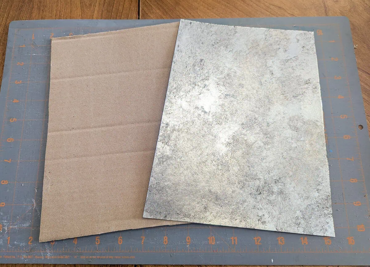 cardboard piece next to cardstock piece before gluing.