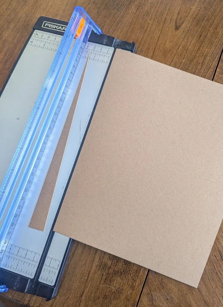 cutting cardstock with paper cutter.