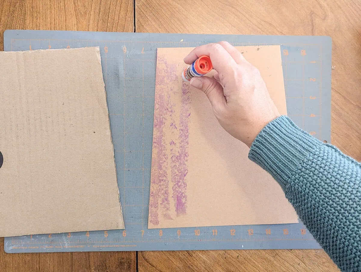 gluing cardstock to cardboard with a glue stick.