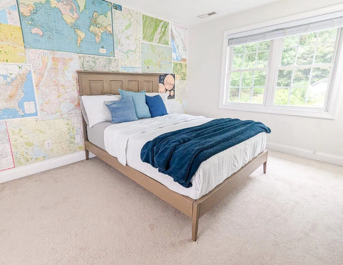 bedroom with map wall and wooden bed.
