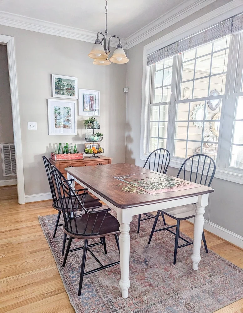 breakfast area with wood table and windsor chairs.
