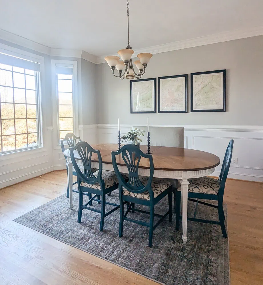 dining room with wood table, blue chairs, and leather bench.