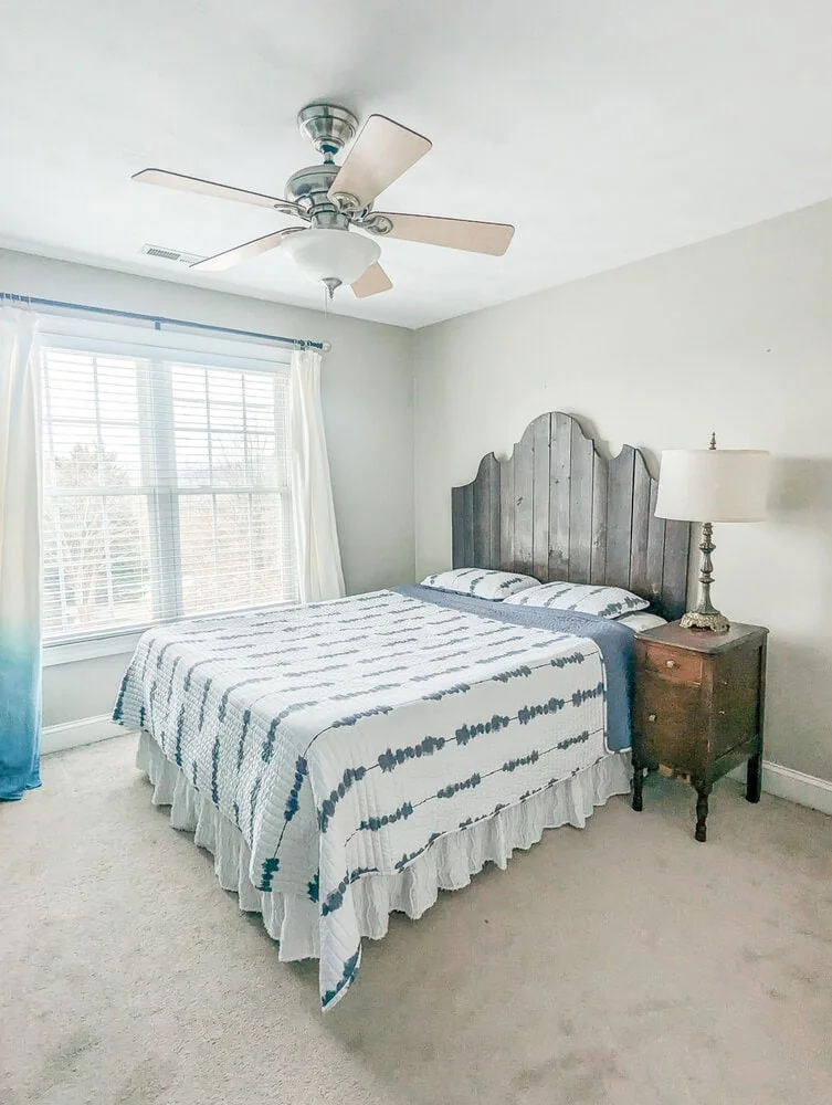 guest room with wood plank headboard.