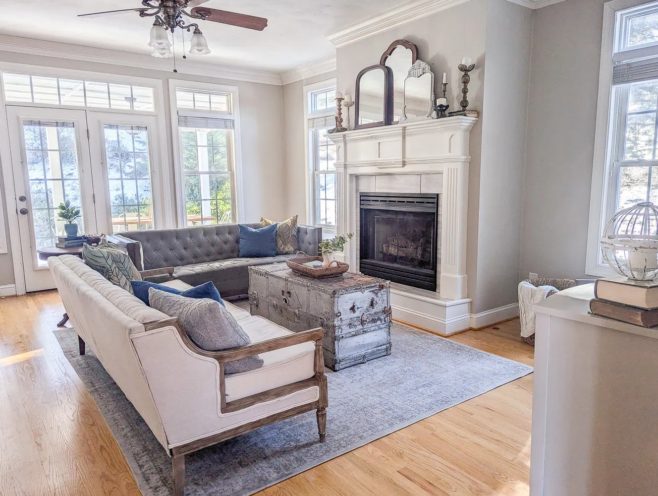 living room with two couches, old trunk coffee table, and fireplace.