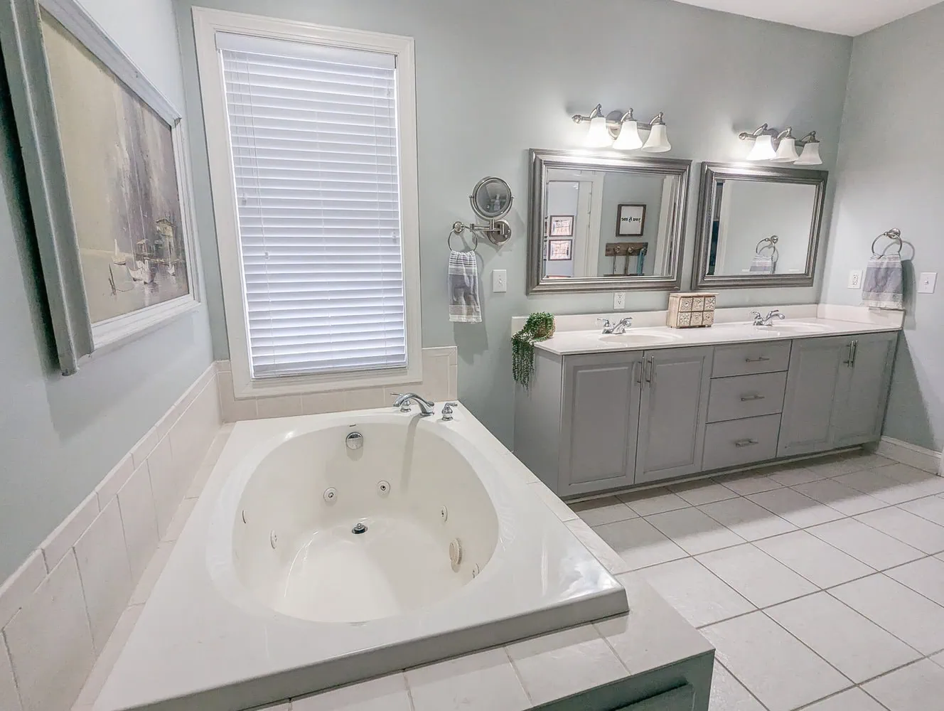 bathroom with jacuzzi tub and double vanity.