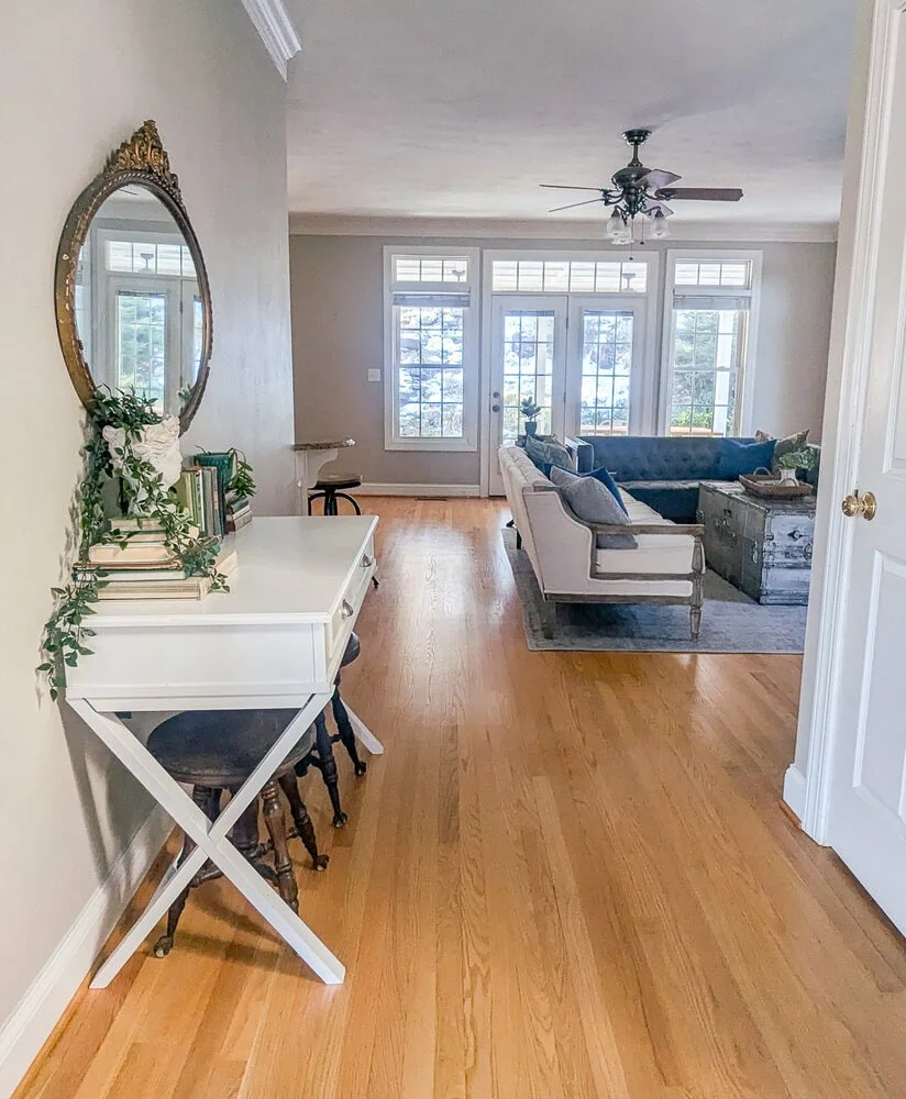 looking into home from front door, entryway with white table leading toward living room.