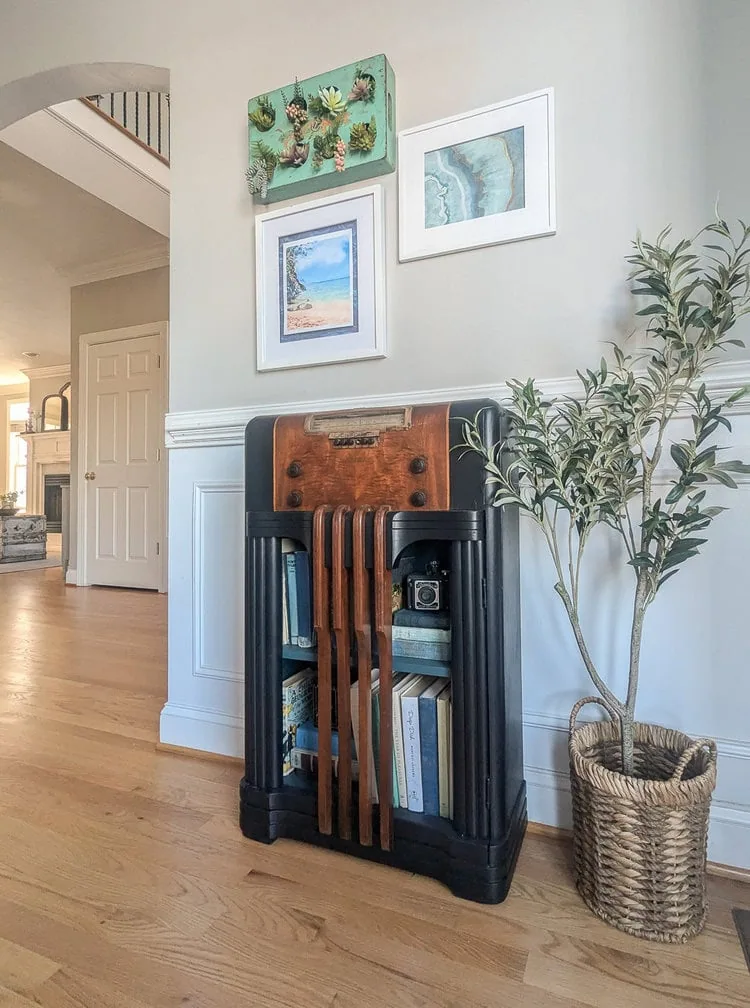 vintage radio turned bookcase in dining room.