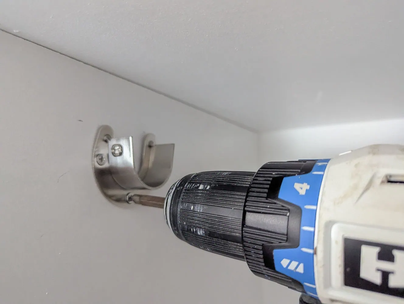 installing closet rod brackets.