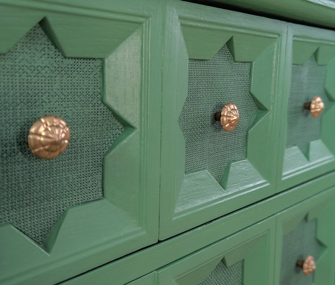 close up of texture on drawers of green nightstand.