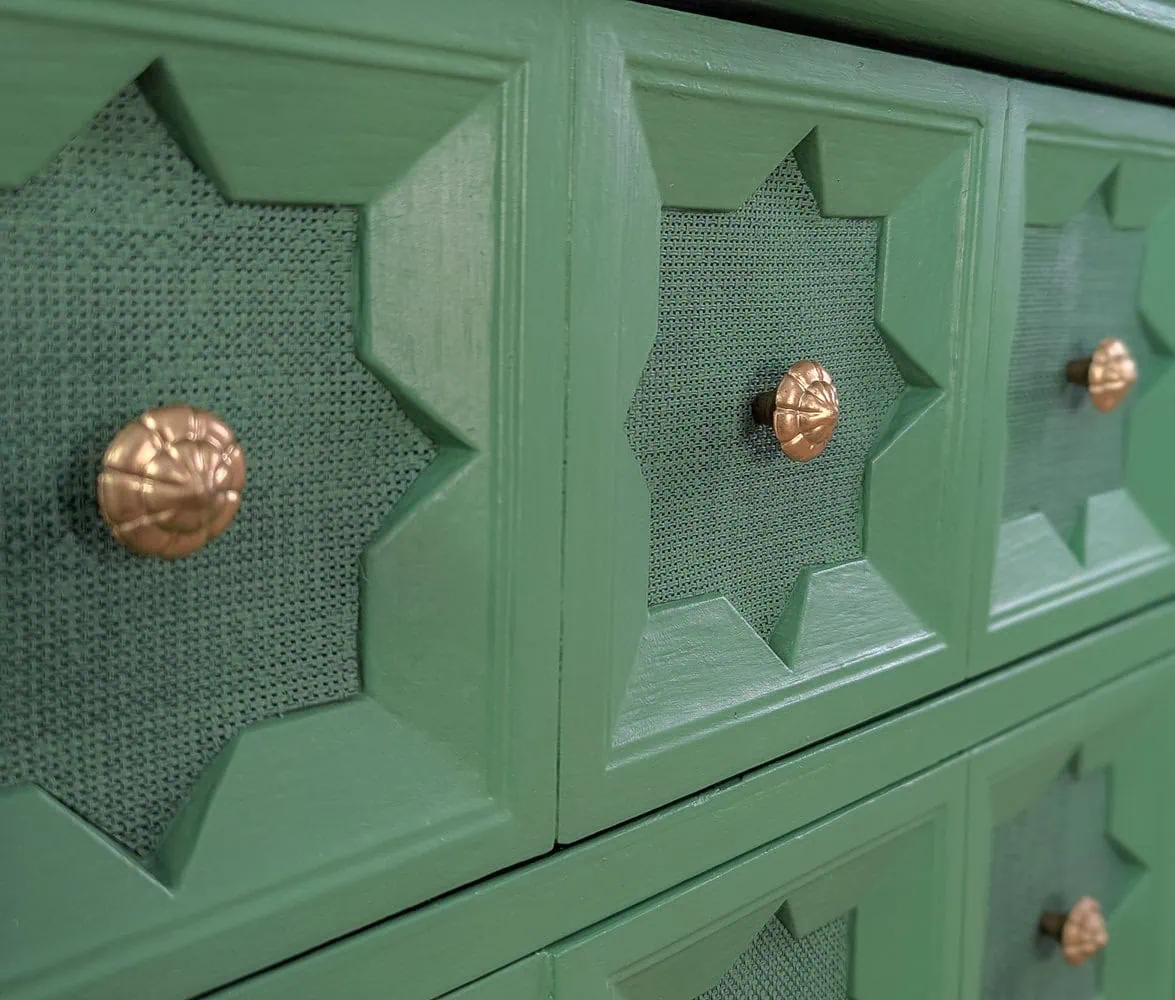 close up of texture on drawers of green nightstand.