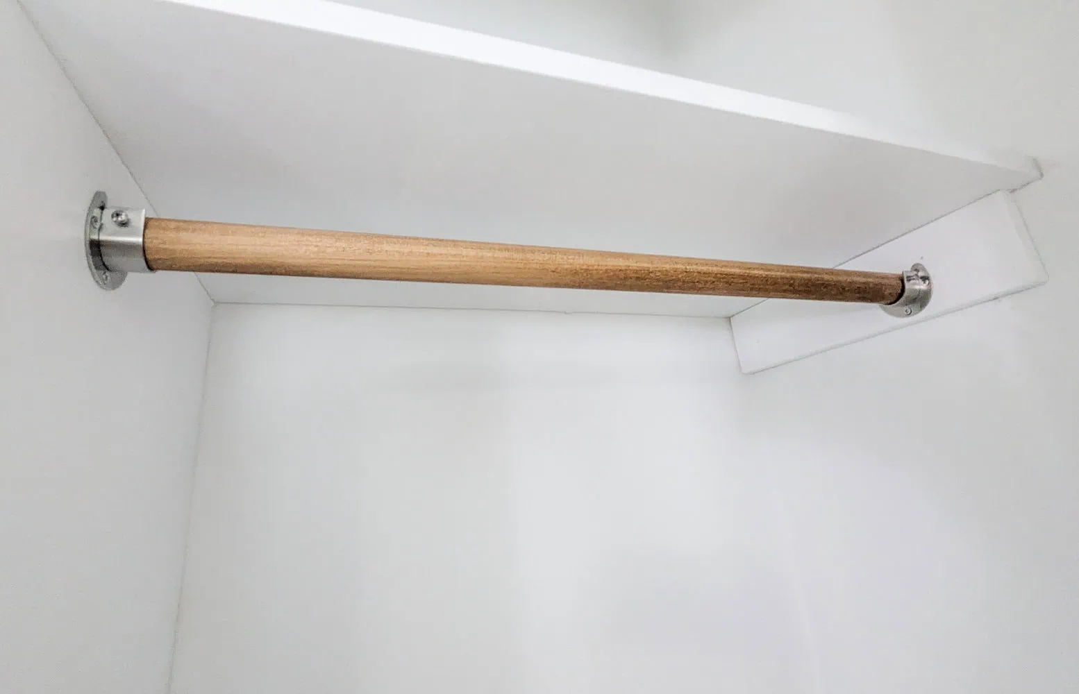 wooden closet rod cut to size and stained.