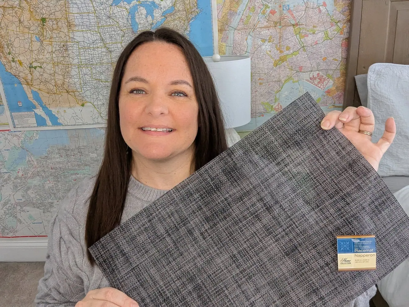 Carrie holding dollar tree placemat.